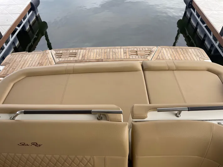  Yacht Photos Pics 2022 Sea Ray 400 SLX boat with tan seating and wooden deck at a dock.