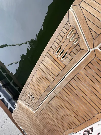  Yacht Photos Pics 2022 Sea Ray 400 SLX boat deck with teak finish by the water.