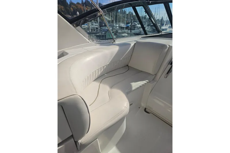 Long Time Comin' Yacht Photos Pics 2000 Cruisers Yachts 4450 Express Motoryacht interior seating with white upholstery.