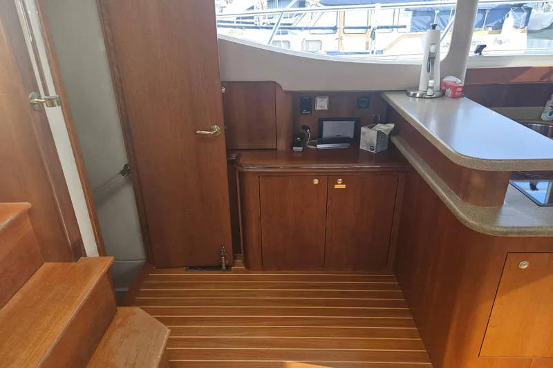 Long Time Comin' Yacht Photos Pics Interior of 2000 Cruisers Yachts 4450 Express Motoryacht with wooden cabinetry and countertop.