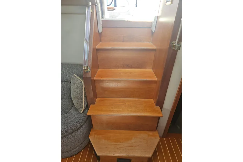 Long Time Comin' Yacht Photos Pics Wooden stairs inside 2000 Cruisers Yachts 4450 Express Motoryacht, featuring sleek handrails.