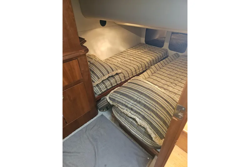 Long Time Comin' Yacht Photos Pics Twin beds in 2000 Cruisers Yachts 4450 Express Motoryacht cabin, featuring striped bedding.