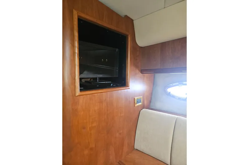 Long Time Comin' Yacht Photos Pics Interior of 2000 Cruisers Yachts 4450 Express Motoryacht with built-in TV and porthole window.