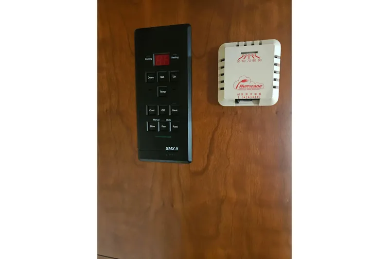 Long Time Comin' Yacht Photos Pics Control panel and thermostat on 2000 Cruisers Yachts 4450 Express Motoryacht interior.