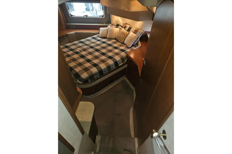 Long Time Comin' Yacht Photos Pics Luxurious cabin interior of 2000 Cruisers Yachts 4450 Express Motoryacht with plaid bedding.