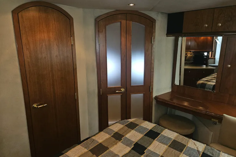 Long Time Comin' Yacht Photos Pics Luxurious 2000 Cruisers Yachts 4450 Express Motoryacht interior with wood doors and vanity.