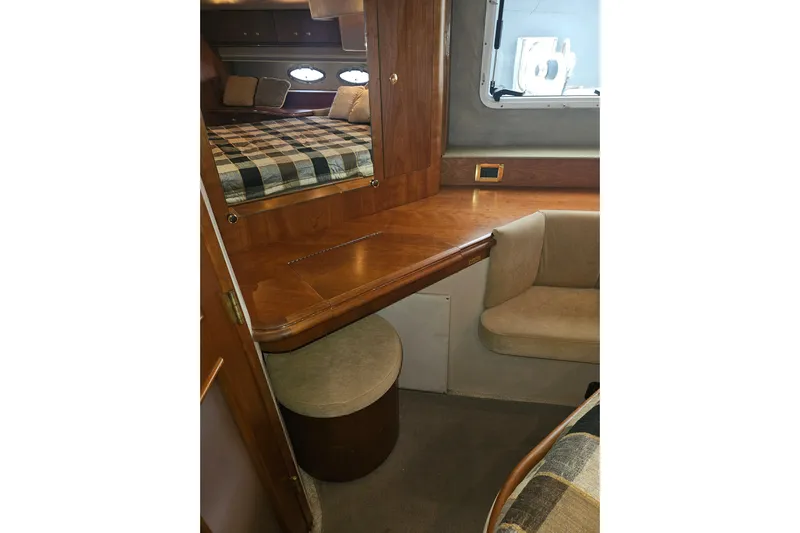 Long Time Comin' Yacht Photos Pics Interior of 2000 Cruisers Yachts 4450 Express Motoryacht with wood finish and seating area.