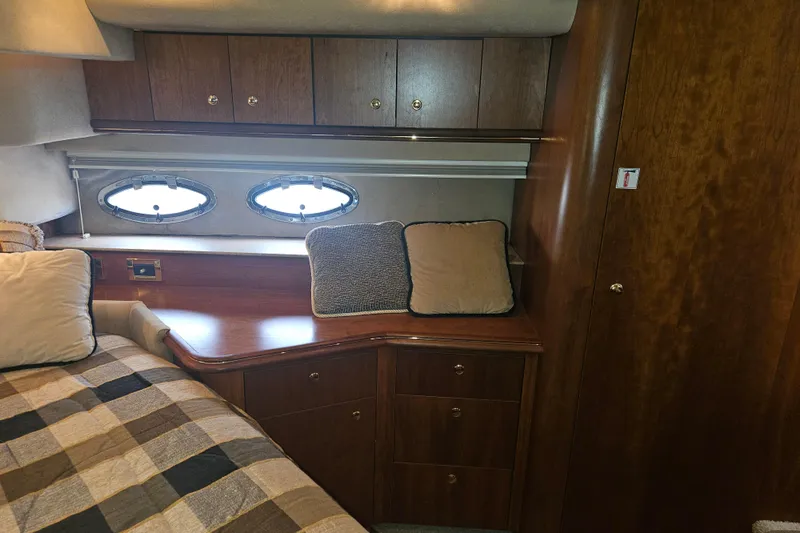 Long Time Comin' Yacht Photos Pics Luxurious cabin interior of 2000 Cruisers Yachts 4450 Express Motoryacht with wood cabinetry.
