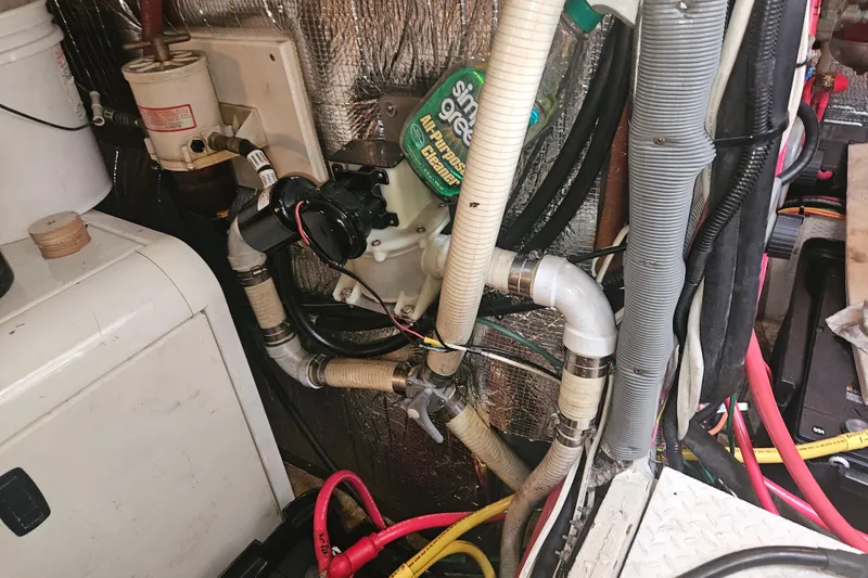 Long Time Comin' Yacht Photos Pics Engine room of 2000 Cruisers Yachts 4450 Express Motoryacht with various pipes and equipment.