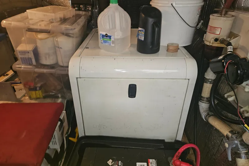 Long Time Comin' Yacht Photos Pics Engine room of 2000 Cruisers Yachts 4450 Express Motoryacht with storage containers and equipment.