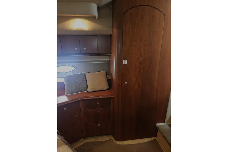 Long Time Comin' Yacht Photos Pics Interior of 2000 Cruisers Yachts 4450 Express Motoryacht with wooden cabinetry and cushions.