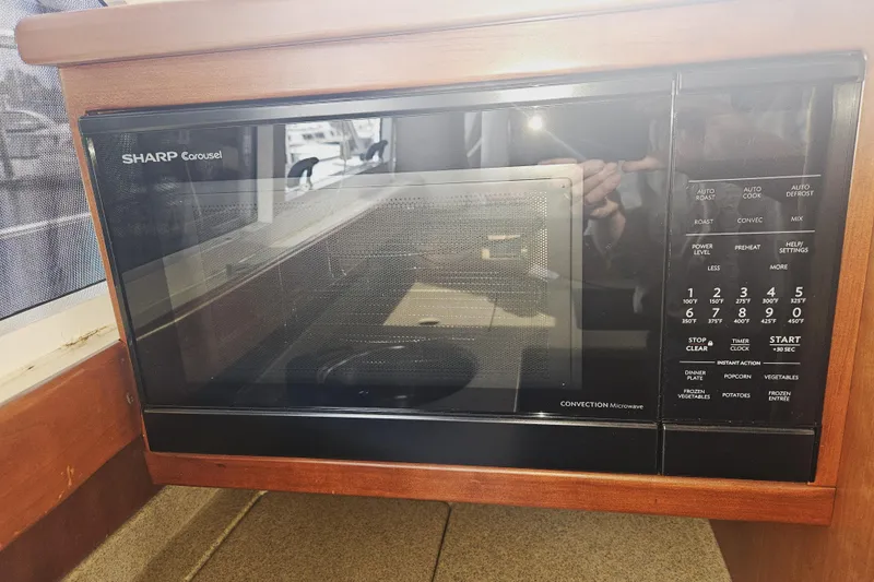 Long Time Comin' Yacht Photos Pics Sharp Carousel microwave in 2000 Cruisers Yachts 4450 Express Motoryacht kitchen.