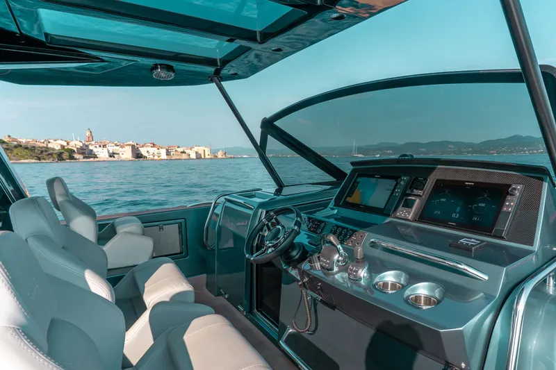  Yacht Photos Pics Interior view of 2021 Pardo Yachts 50, featuring modern helm and coastal scenery.