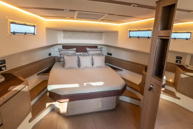  Yacht Photos Pics Luxurious cabin interior of 2021 Pardo Yachts 50, featuring elegant bedding and ambient lighting.