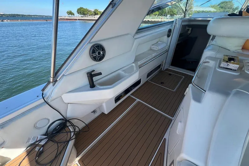 Abeona Yacht Photos Pics 1997 Sea Ray 500 Sundancer interior with teak flooring and lake view.