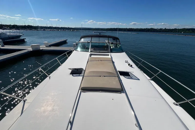 Abeona Yacht Photos Pics 1997 Sea Ray 500 Sundancer yacht docked on a sunny day, with clear blue water.