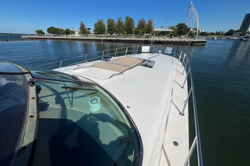 Abeona Yacht Photos Pics 1997 Sea Ray 500 Sundancer yacht docked in a scenic marina setting.