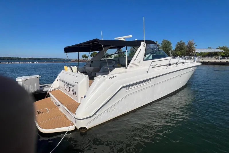 Abeona Yacht Photos Pics 1997 Sea Ray 500 Sundancer yacht docked on a sunny day, featuring sleek design and spacious deck.