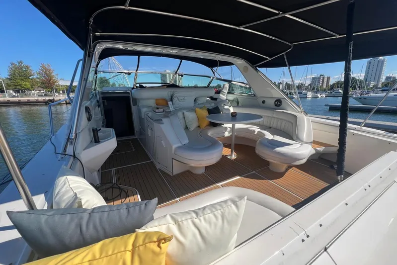 Abeona Yacht Photos Pics Luxurious 1997 Sea Ray 500 Sundancer yacht interior with seating and table, docked at marina.
