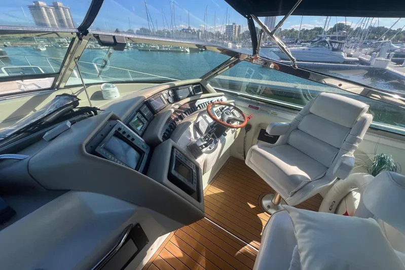 Abeona Yacht Photos Pics Helm of 1997 Sea Ray 500 Sundancer yacht with modern controls and luxurious seating.