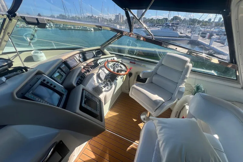 Abeona Yacht Photos Pics Interior cockpit of 1997 Sea Ray 500 Sundancer yacht with steering wheel and controls.