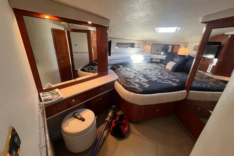 Abeona Yacht Photos Pics Luxurious 1997 Sea Ray 500 Sundancer cabin with elegant bedding and wood accents.