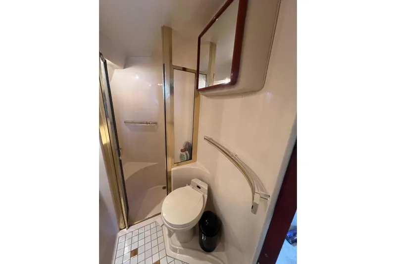 Abeona Yacht Photos Pics Bathroom interior of 1997 Sea Ray 500 Sundancer yacht, featuring shower and toilet.