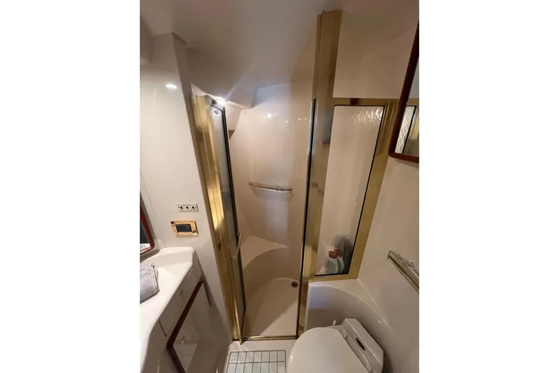 Abeona Yacht Photos Pics Bathroom interior of 1997 Sea Ray 500 Sundancer yacht with shower and toilet.