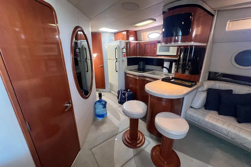 Abeona Yacht Photos Pics Luxurious interior of a 1997 Sea Ray 500 Sundancer yacht with modern kitchen and seating.