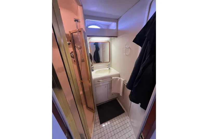 Abeona Yacht Photos Pics Bathroom interior of 1997 Sea Ray 500 Sundancer yacht with shower and sink.