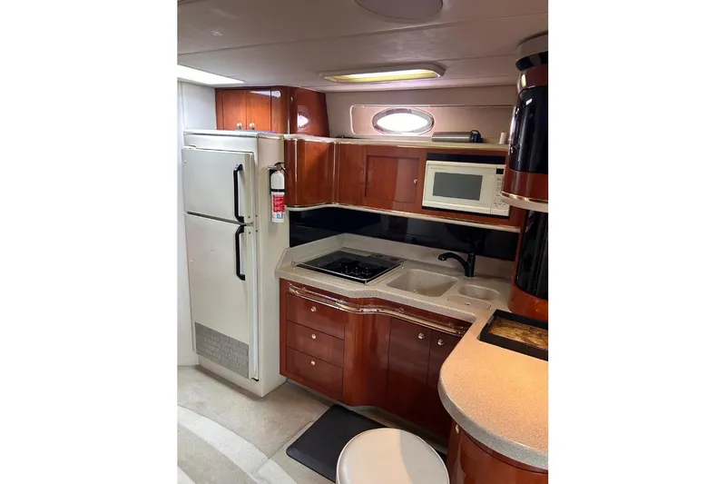 Abeona Yacht Photos Pics Luxurious 1997 Sea Ray 500 Sundancer yacht kitchen with modern appliances and elegant wood cabinetry.