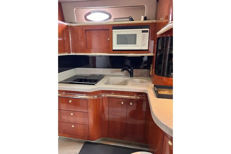 Abeona Yacht Photos Pics Luxurious 1997 Sea Ray 500 Sundancer yacht kitchen with wood cabinetry and modern appliances.