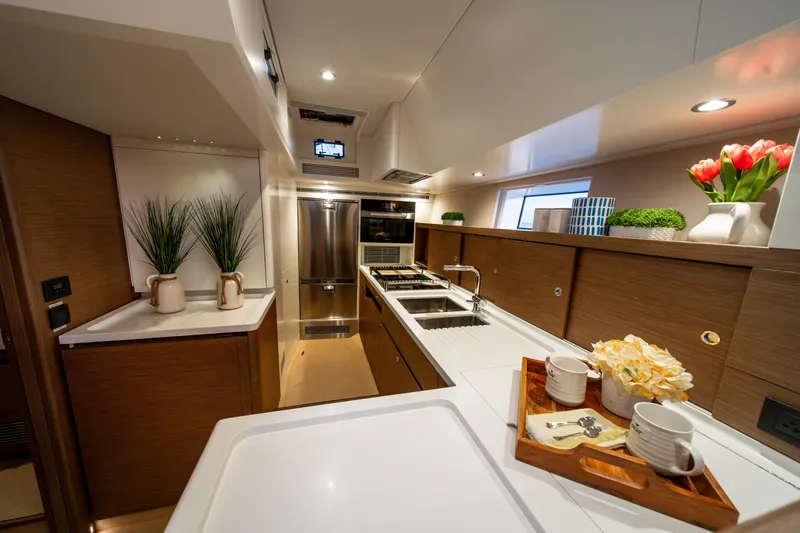 Fortitude Yacht Photos Pics Luxurious yacht kitchen interior with modern appliances, elegant decor, and ample counter space.