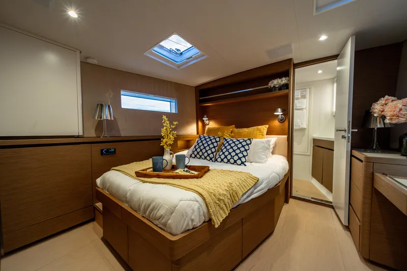 Fortitude Yacht Photos Pics Luxurious CNB 66 yacht bedroom, 2021 model, with cozy bed and elegant decor.