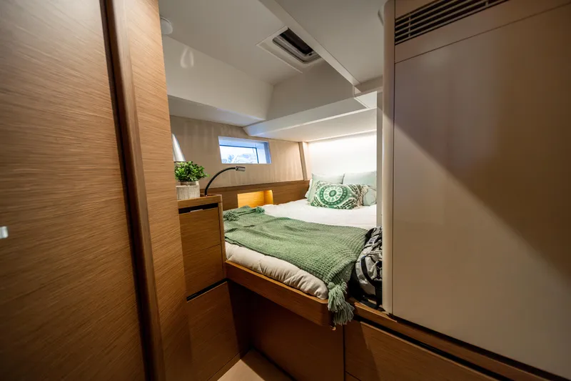 Fortitude Yacht Photos Pics Luxurious cabin interior of 2021 CNB 66 yacht with cozy bedding and modern design.