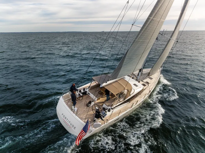 Fortitude Yacht Photos Pics Sailing yacht CNB 66, 2021 model, cruising on open sea with American flag.