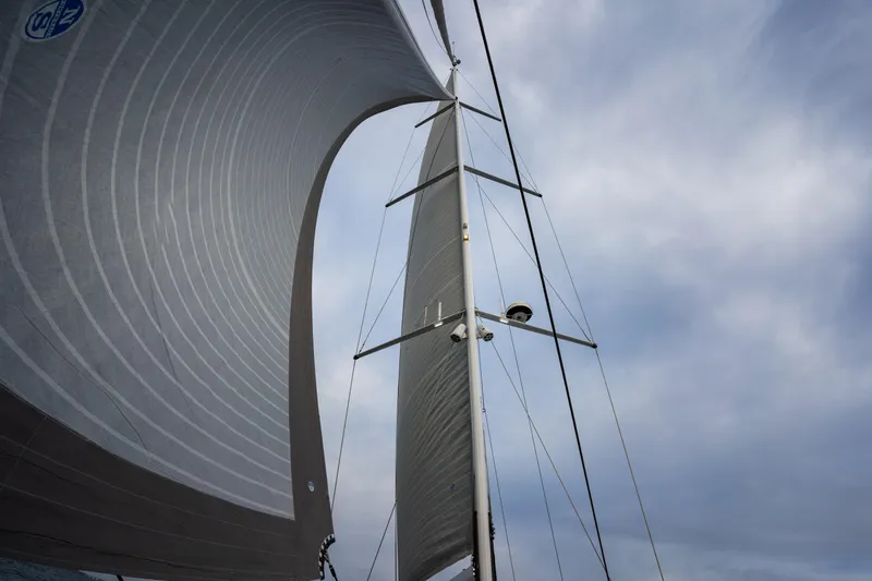 Fortitude Yacht Photos Pics Sailing yacht CNB 66, 2021 model, with sails unfurled against a cloudy sky.