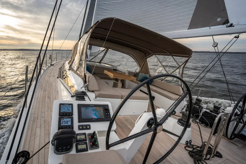 Fortitude Yacht Photos Pics Luxurious 2021 CNB 66 yacht sailing at sunset with modern cockpit and navigation equipment.