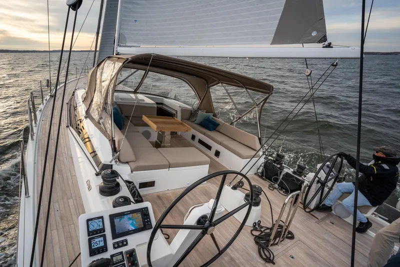 Fortitude Yacht Photos Pics Luxurious 2021 CNB 66 yacht sailing on open water at sunset.