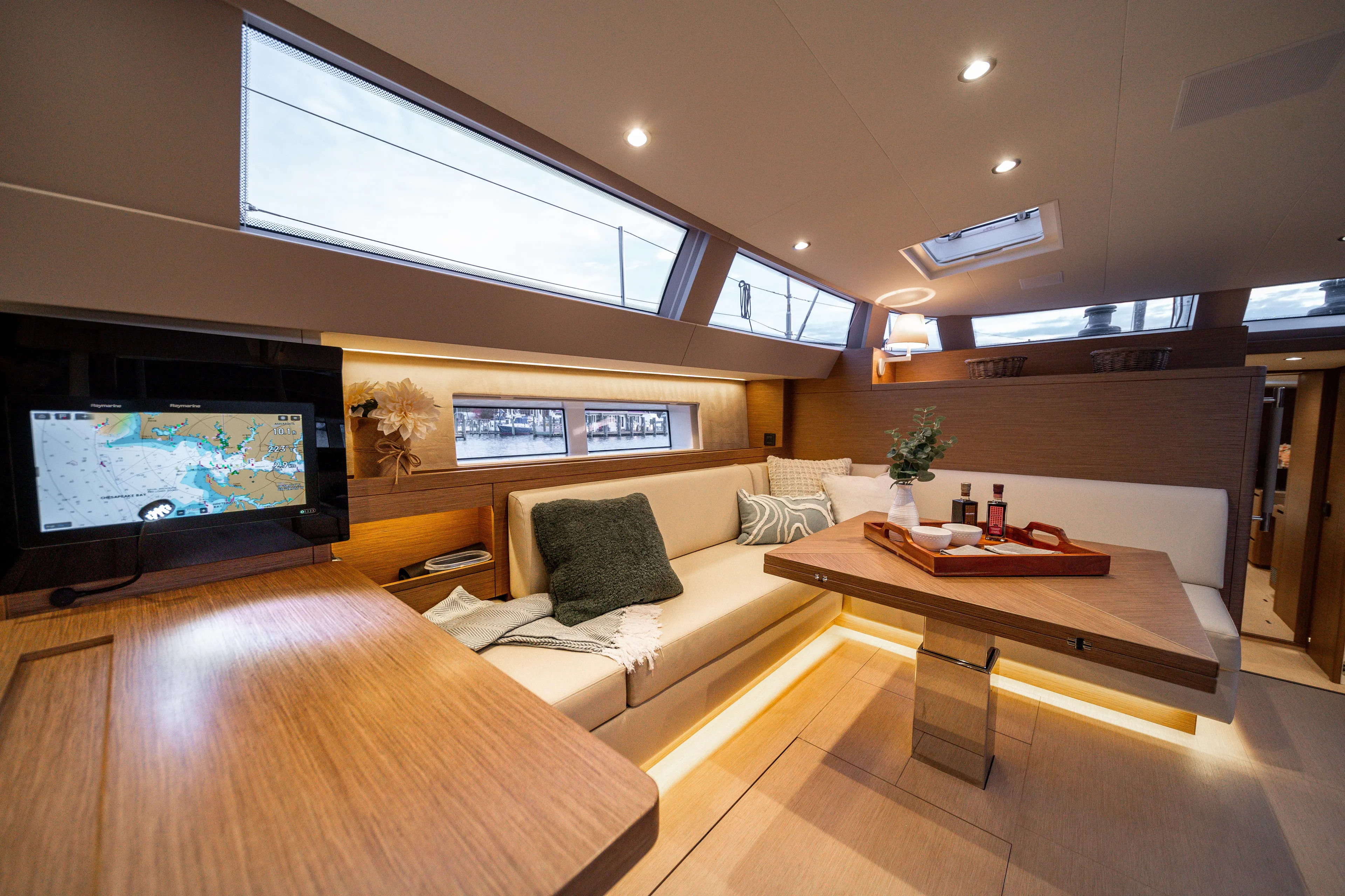 Fortitude Yacht Photos Pics Luxurious interior of 2021 CNB 66 yacht with modern seating and navigation screen.