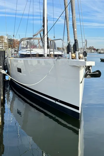 Fortitude Yacht Photos Pics Sleek 2021 CNB 66 yacht docked in calm marina waters.