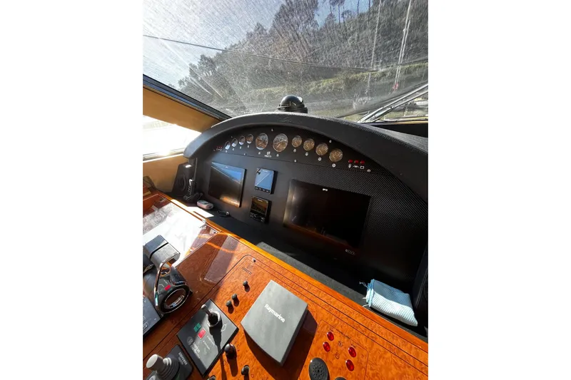 M/y "catherine" Yacht Photos Pics Control panel of a 2002 Ferretti Yachts 680, featuring navigation instruments and displays.