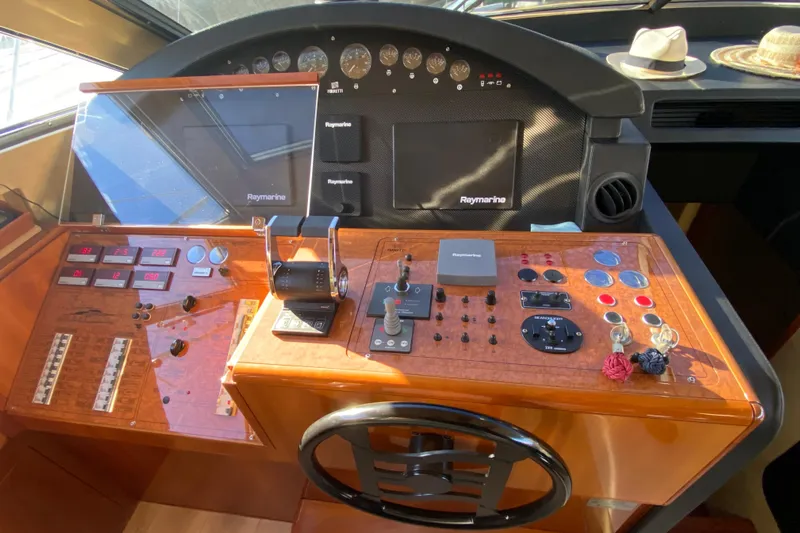 M/y "catherine" Yacht Photos Pics Cockpit of 2002 Ferretti Yachts 680 with navigation controls and steering wheel.