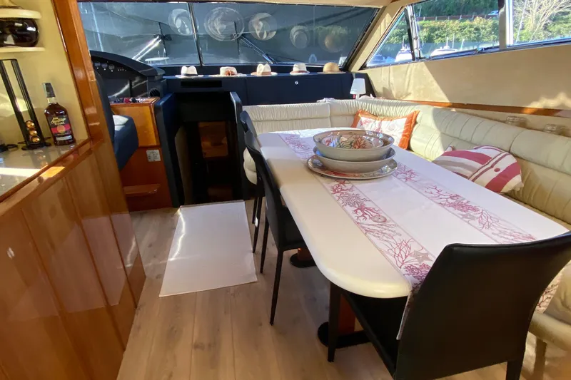 M/y "catherine" Yacht Photos Pics Luxurious interior of 2002 Ferretti Yachts 680 with elegant dining area and stylish decor.