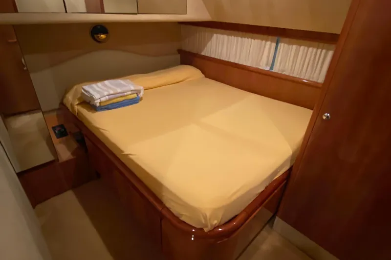 M/y "catherine" Yacht Photos Pics Luxurious bedroom interior of 2002 Ferretti Yachts 680 with cozy bedding.