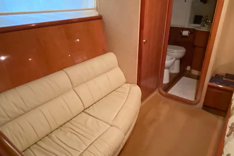 M/y "catherine" Yacht Photos Pics Luxurious interior of 2002 Ferretti Yachts 680 with beige sofa and bathroom.