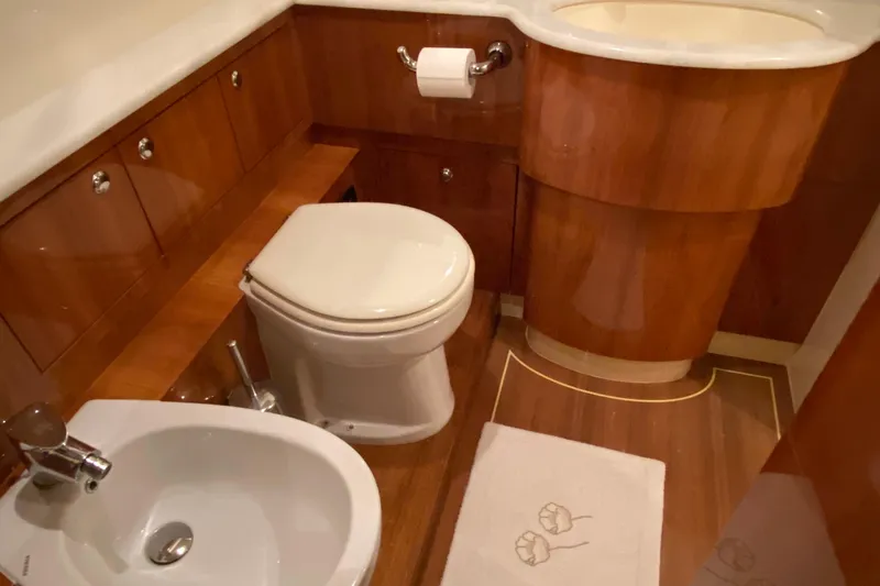M/y "catherine" Yacht Photos Pics Luxurious bathroom in 2002 Ferretti Yachts 680 with wood accents and modern fixtures.