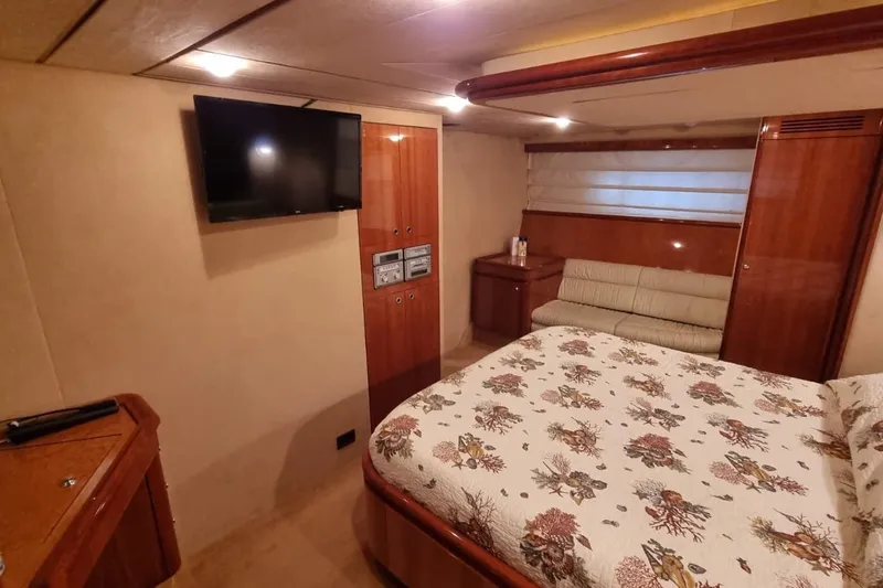 M/y "catherine" Yacht Photos Pics Luxurious cabin interior of 2002 Ferretti Yachts 680 with TV and elegant furnishings.
