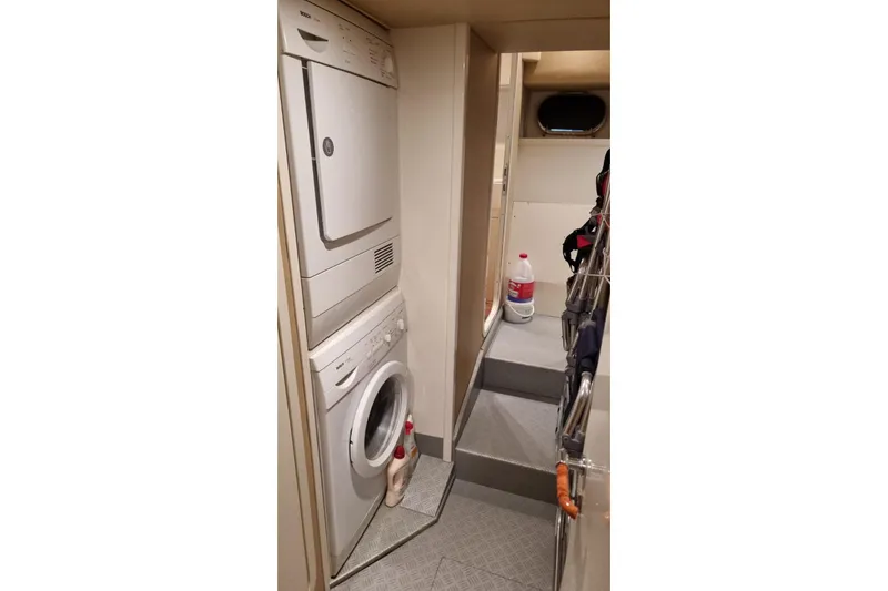 M/y "catherine" Yacht Photos Pics Laundry area inside 2002 Ferretti Yachts 680, featuring stacked washer and dryer.