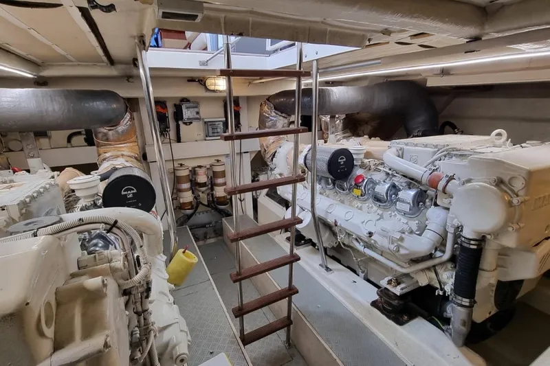 M/y "catherine" Yacht Photos Pics Engine room of 2002 Ferretti Yachts 680, featuring dual engines and central ladder access.